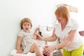 Children's doctor weighing the baby girl