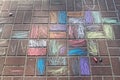 Children`s drawing with colored chalks on paving tiles
