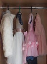 Children `s dress-up dresses on a hanger, children `s things, outfits for little ones