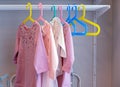 Children`s dresses on colorful coat hangers. Children`s clothing, children`s stores