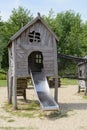 Children`s eco playground. Little wooden house with a slide for children on the ecological playground