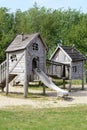 Children`s eco playground. Two little wooden houses with a slide for children on the ecological playground