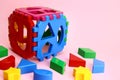 Children's educational game cube sorter on a pink background