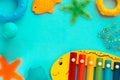 Children`s educational and music games, frame from multicolored kids toys on blue paper background. Sea, ocean concept Royalty Free Stock Photo