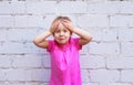 Children`s emotions. Beautiful girl shows how much she is surprised Royalty Free Stock Photo