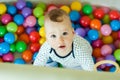 Children`s emotions. Happy baby boy playing with balls Royalty Free Stock Photo