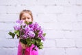 Children`s emotions. Happy child with a bouquet of lilac in his hands Royalty Free Stock Photo