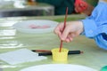 Children`s entertainment -paint stones. Painted with paints stones and jars of paint, leisure for the child, children`s creativi