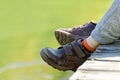 Children`s feet in brown leather shoes over the water Royalty Free Stock Photo