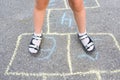 Children`s feet close-up on the pavement. View from above. Outdoor games