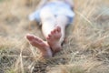 Children`s feet in the grass girl lying on grass relaxing Royalty Free Stock Photo