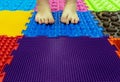 Baby Feet on a Special Orthopedic Carpet. Background