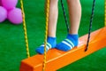 Children`s feet at the playground with swinging bridge Royalty Free Stock Photo