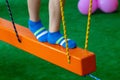 Children`s feet at the playground with swinging bridge Royalty Free Stock Photo