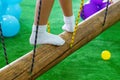 Children`s feet at the playground with swinging bridge Royalty Free Stock Photo