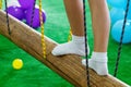 Children`s feet at the playground with swinging bridge Royalty Free Stock Photo