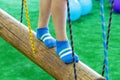 Children`s feet at the playground with swinging bridge Royalty Free Stock Photo