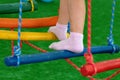 Children`s feet at the playground with swinging bridge Royalty Free Stock Photo