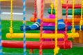 Children`s feet at the playground with swinging bridge Royalty Free Stock Photo