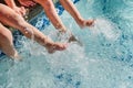 Children`s feet splashing in pool water