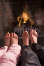 Children's feet warming at a fireplace