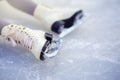 Children`s figure skates on an ice rink close-up. Figure skating - winter sport Royalty Free Stock Photo