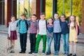 Children`s friendship. Schoolmate students stand in an embrace on the schoolyard. Royalty Free Stock Photo