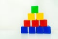 Children`s game blocks. Turret of colored cubes. Plastic toys for preschoolers