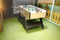 Children`s game - table football with figures of football players of both teams in a wooden box in the playroom for teenagers. Royalty Free Stock Photo