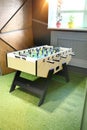 Children`s game - table football with figures of football players of both teams in a wooden box in the playroom for teenagers. Royalty Free Stock Photo