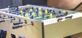 Children`s game - table football with figures of football players of both teams in a wooden box in the playroom for teenagers. Royalty Free Stock Photo