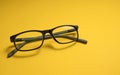 Children`s glasses lie on a yellow close-up with space for text. Copy Space. The concept of children`s myopia, astigmatism, visi Royalty Free Stock Photo