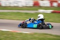 Children`s go-karting. A child is driving a cart along the track at speed Royalty Free Stock Photo