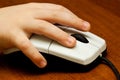 Children's hand on computer mouse Royalty Free Stock Photo