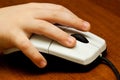 Children's hand on computer mouse Royalty Free Stock Photo