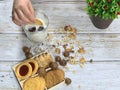 Children`s hand with cookies dunks in milk. Royalty Free Stock Photo