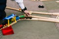 Children`s hand drives a toy wooden train. An exciting game for children in kindergarten or school