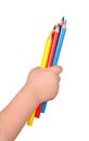 Children's hand holds the colorful pencils