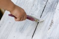 Painting a wooden surface with white paint with a paint brush Royalty Free Stock Photo