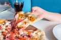 Childrens hand with pizza, closeup on the table