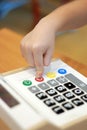 Children`s hand presses on button calculator Royalty Free Stock Photo