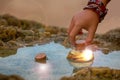 Children`s hand pulls from the pond glowing magic bottle