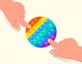 Children`s hands burst bubbles with their fingers. Children`s toy, silicone Pop it anti stress toy.