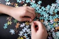 Children`s hands collect puzzles