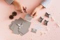 Children`s hands cut out blanks for making an advent calendar on a table in Christmas decorations