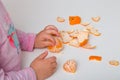 Children`s hands divide tangerine