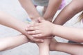 Children`s hands are folded on top of each other. Symbol of unity and teamwork.