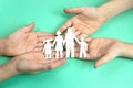 Children's hands hold a family with children cut out of paper . Family traditions concept. Children dream of Royalty Free Stock Photo