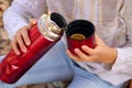 Children`s hands hold a red mug with tea in the autumn park Royalty Free Stock Photo