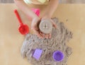 Children`s hands holding a cupcake made of kinetic sand. Royalty Free Stock Photo